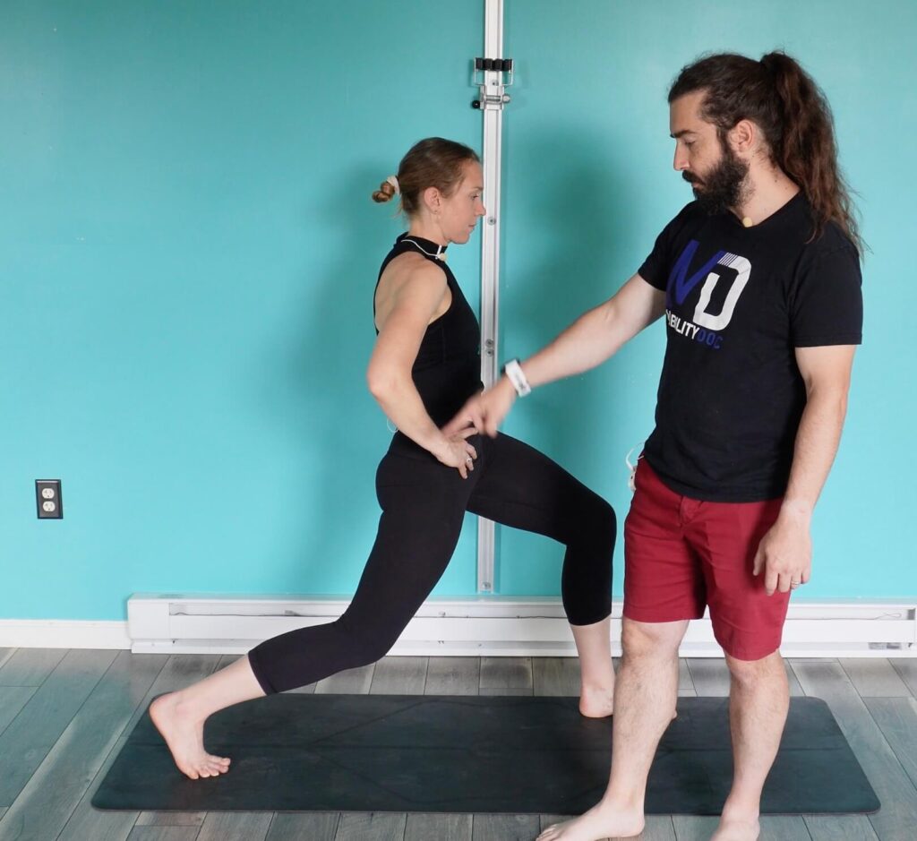 Dr. Chloe in a lunge stretch, left foot forward, right foot back, squeezing her right glute to open the front of her hip as part of glute activation exercises